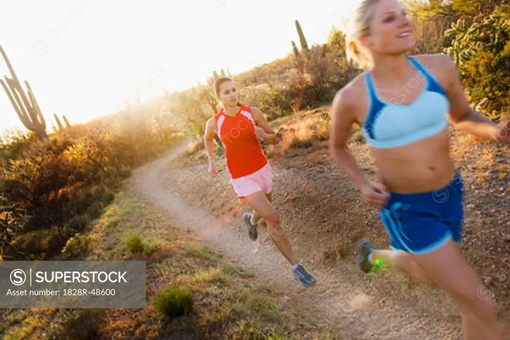 Women Running on Desert Trail, Saguaro National Park, Arizona, USA   