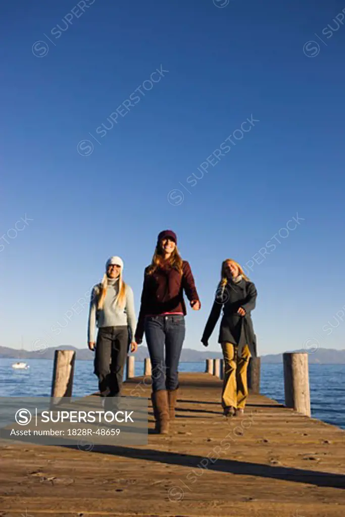 Three Women Walking on Dock   