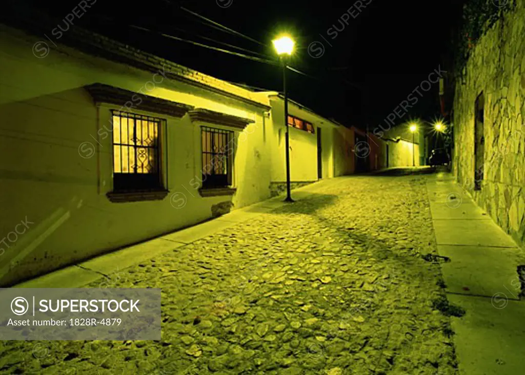 Buildings and Cobblestone Street At Night, Oaxace, Mexico   