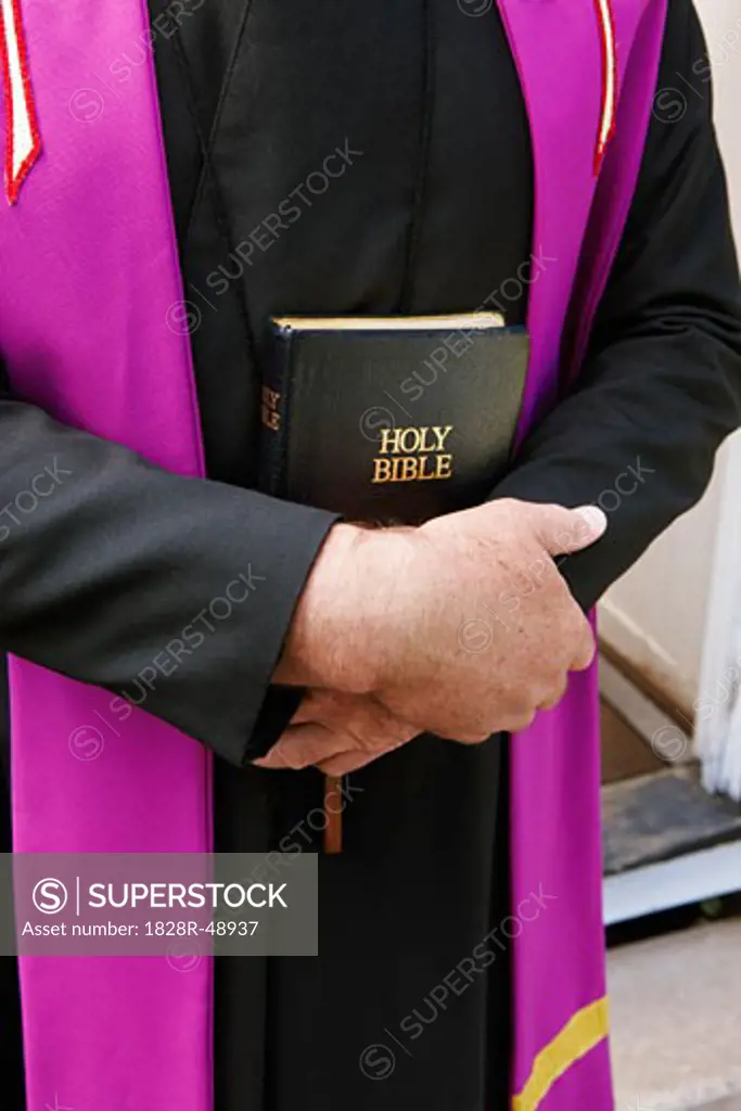 Close-up of Priest Holding Bible   