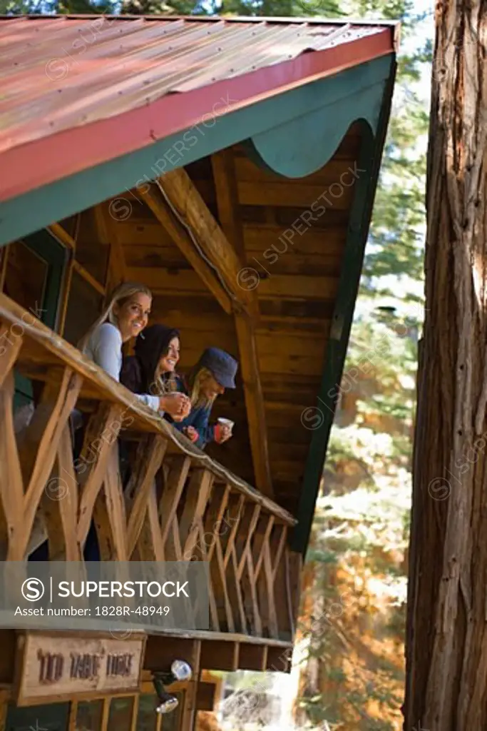 Women on Cabin Balcony, Lake Tahoe, California, USA   