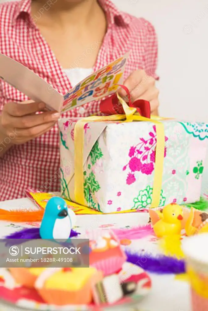 Woman Reading Birthday Card at Party   