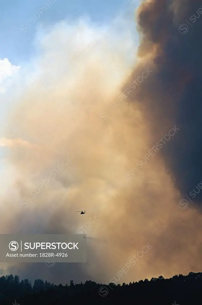 Smoke from Forest Fire with Fire Fighting Helicopter   