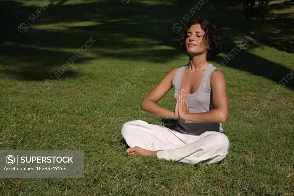 Woman in Lotus Pose in Park, Rome, Italy   