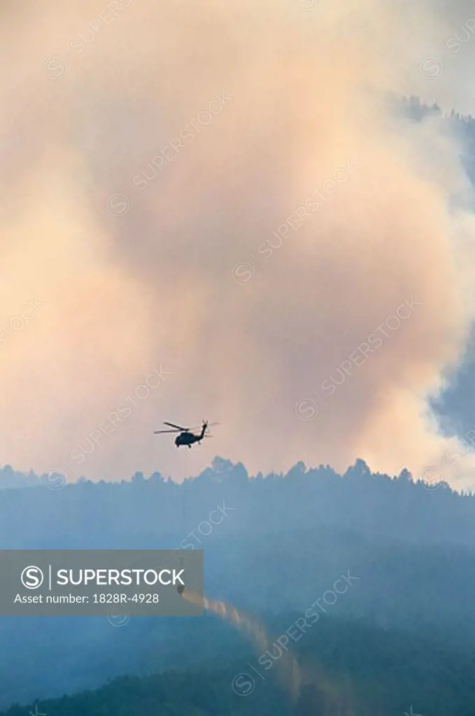 Smoke from Forest Fire with Fire Fighting Helicopter   