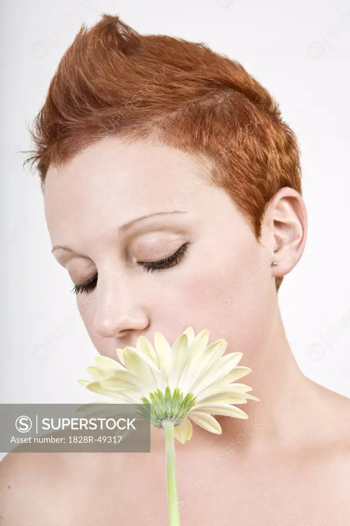Portrait of Woman Smelling a Flower   