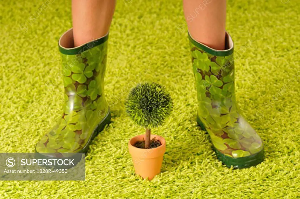 Woman in Rubber Boots with Potted Plant   