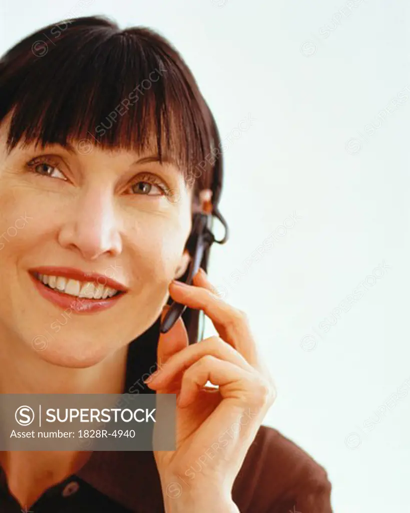 Portrait of Businesswoman Using Telephone Headset   