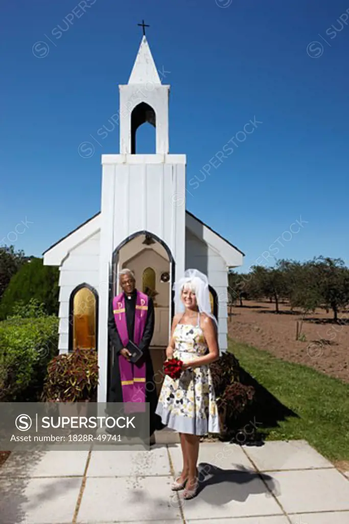 Bride and Priest Standing in Front of Church, Niagara Falls, Ontario, Canada   