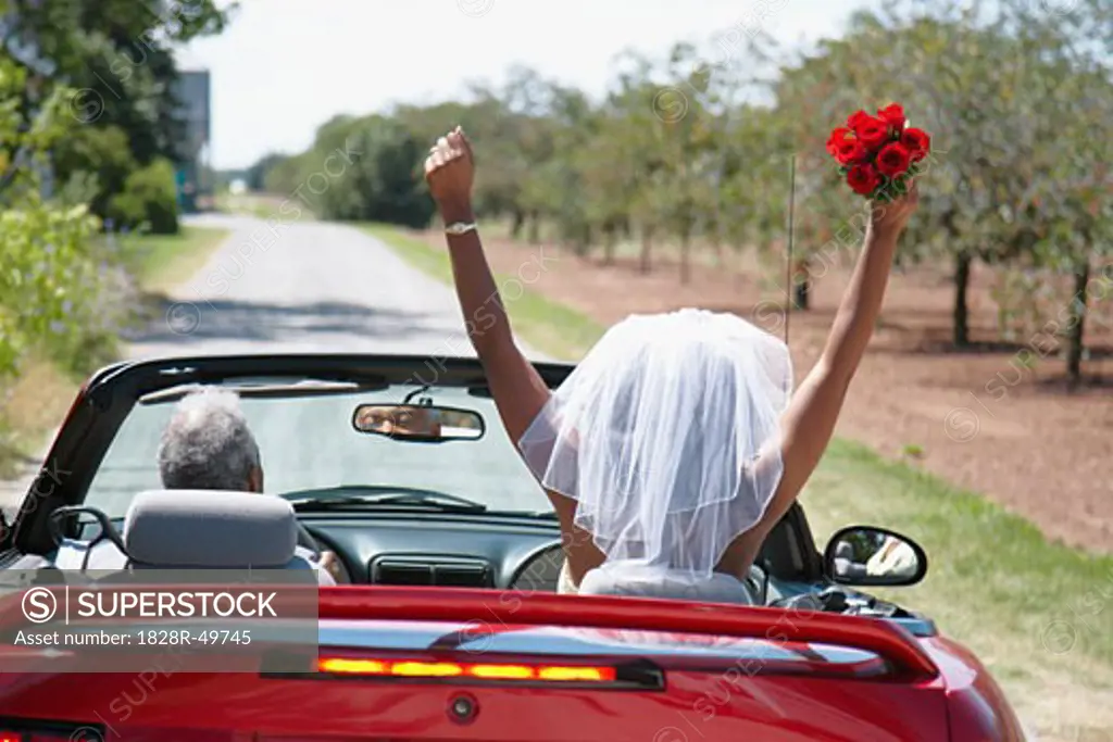 Bride and Groom Driving Away in Convertible, Niagara Falls, Ontario, Canada   