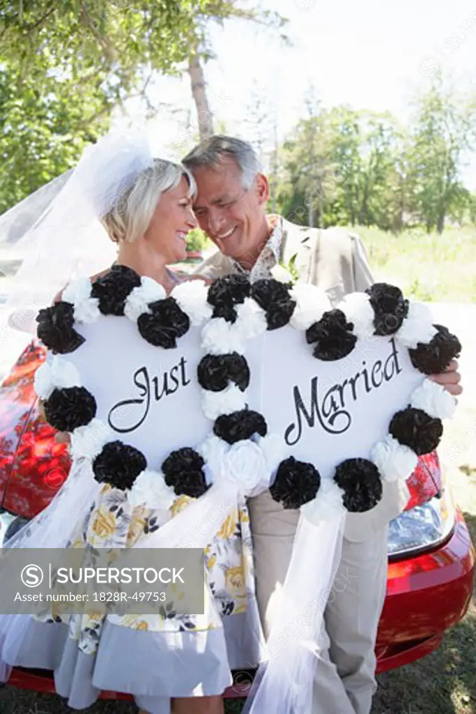 Newlyweds Holding Just Married Sign   