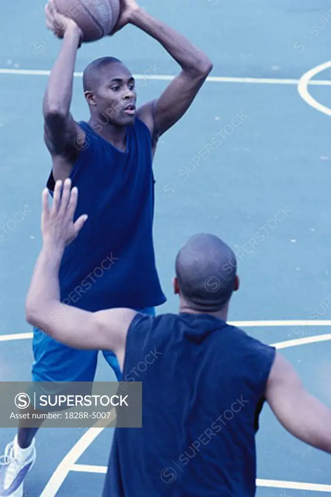 Men Playing Basketball Outdoors   