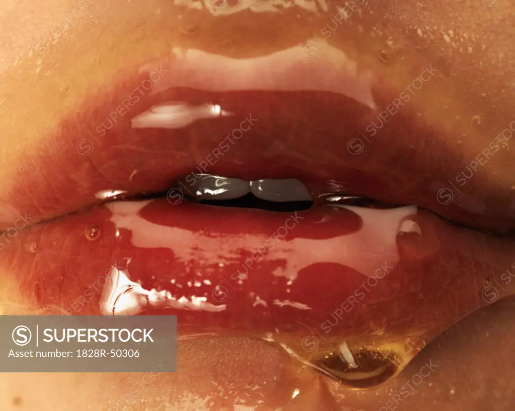 Close-up of Honey on Woman's Lips   