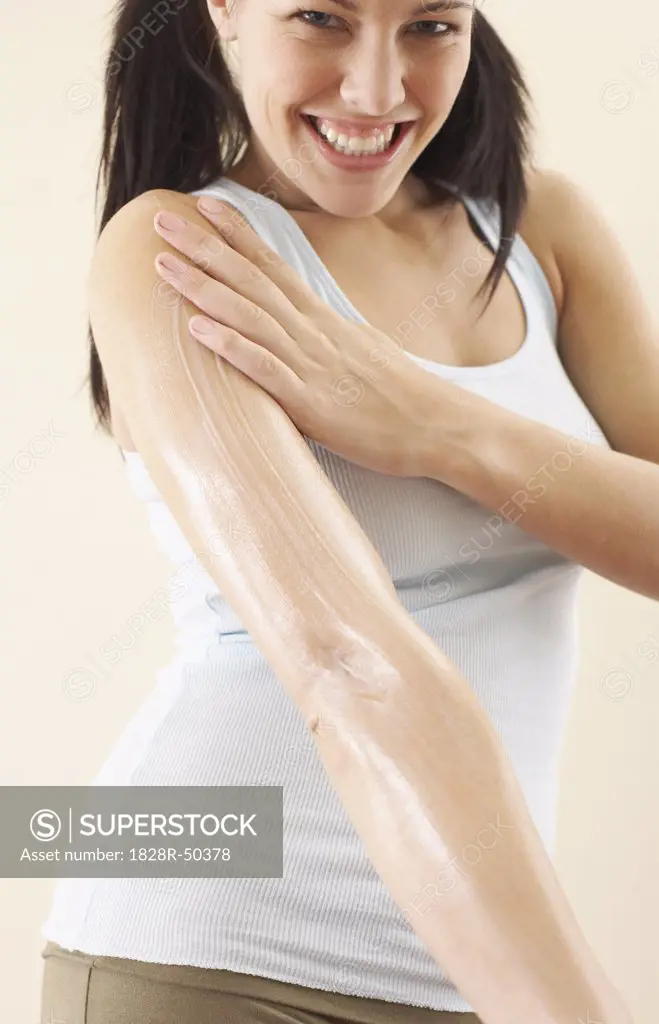Woman Rubbing Lotion on Arm   