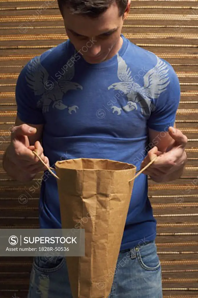 Man Holding Paper Bag   