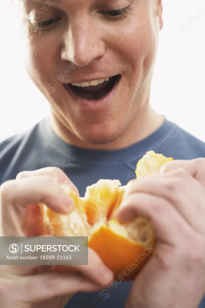 Man Peeling Orange   