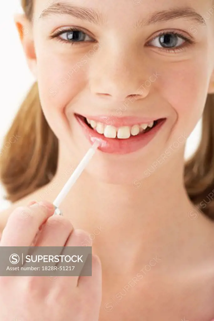 Girl Applying Lip Gloss   