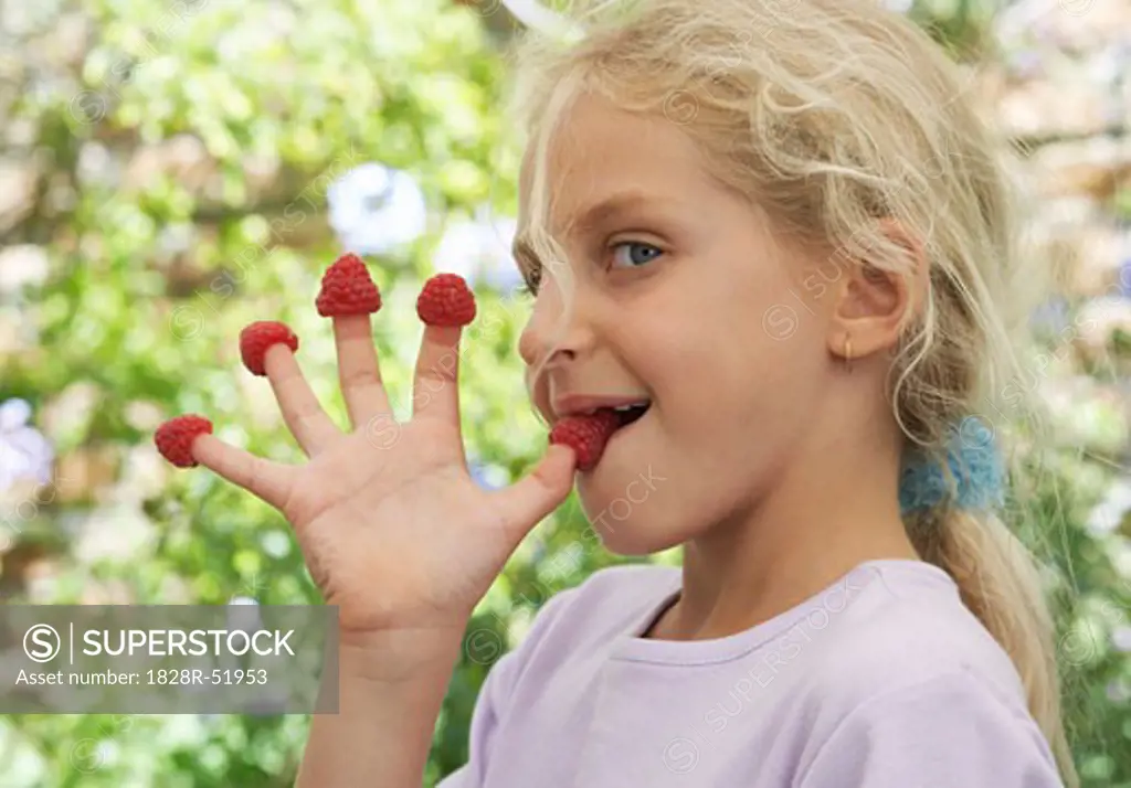 Girl Wearing Raspberries On Her Fingers   