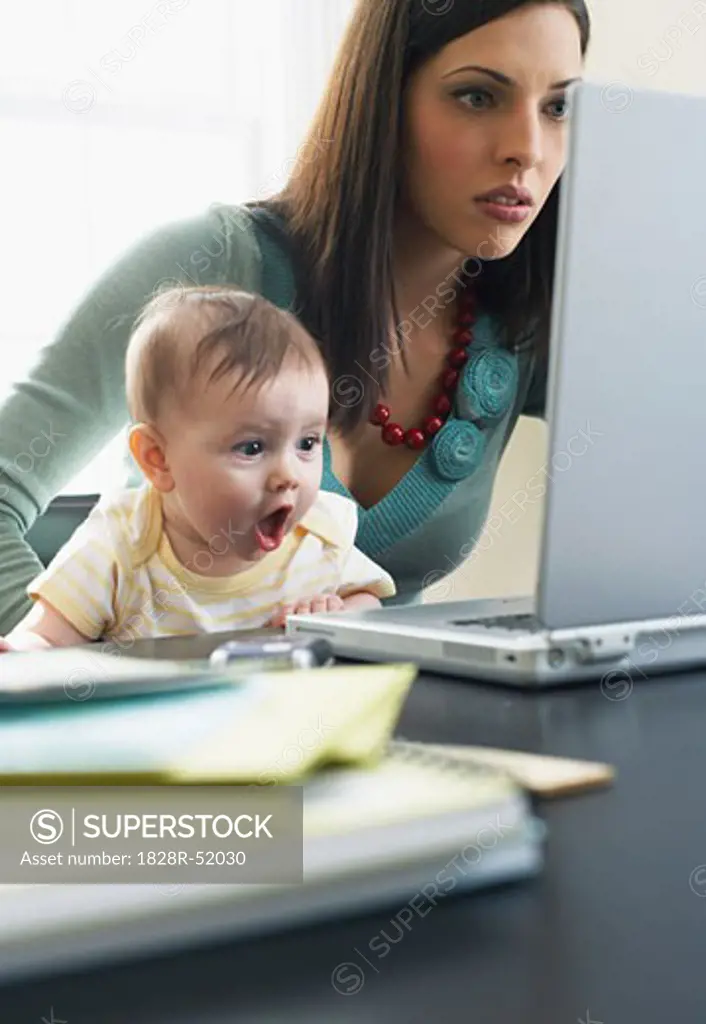 Mother and Baby Looking at Laptop Computer   