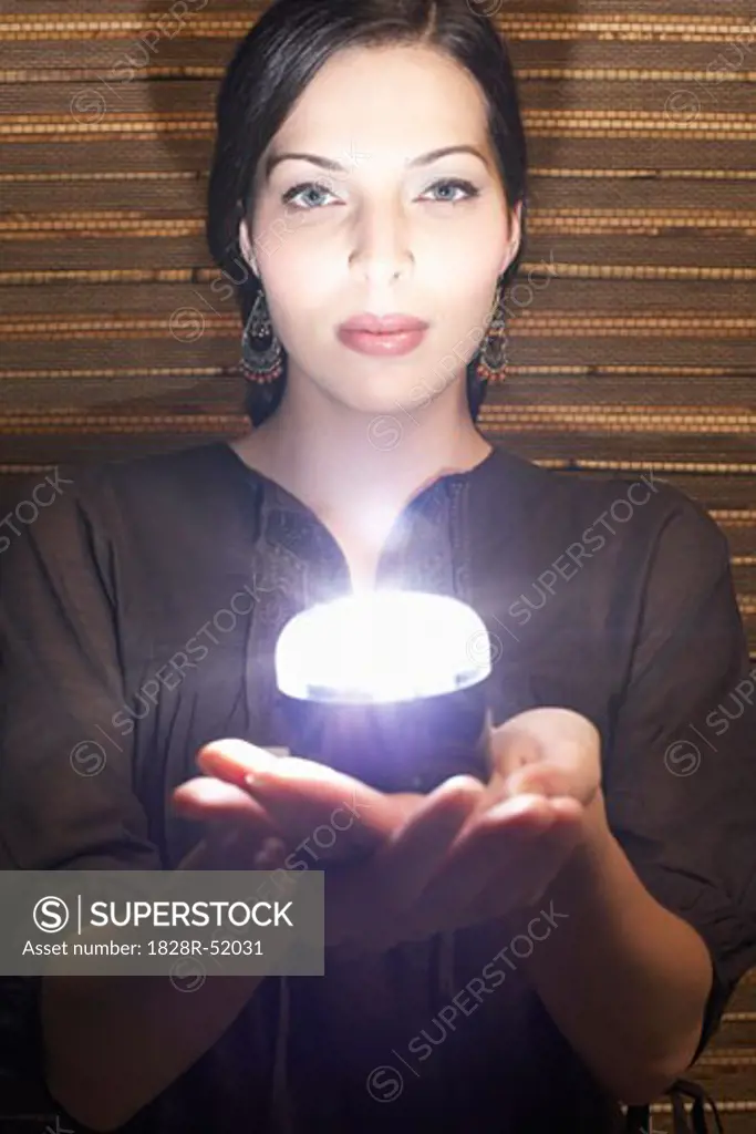 Woman Holding Glowing Object   