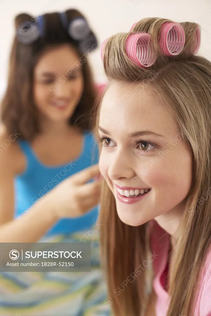 Girls Curling Hair Together   