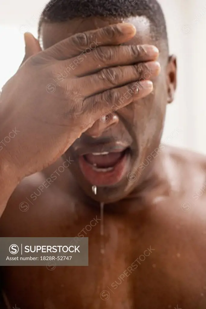 Man Splashing Water on Face   