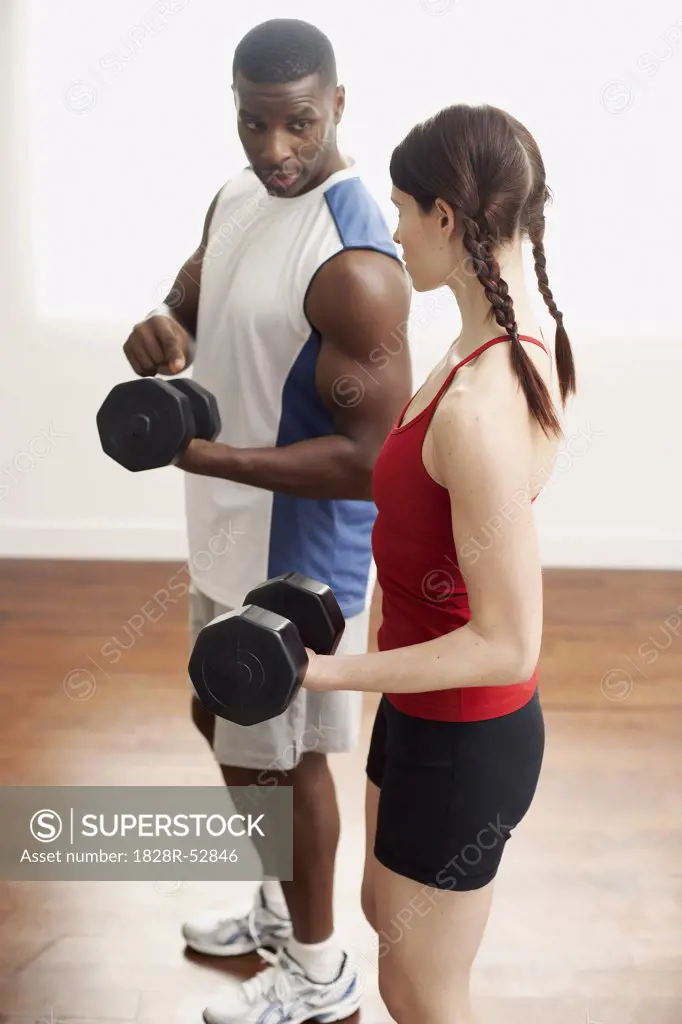 Man and Woman Lifting Weights   