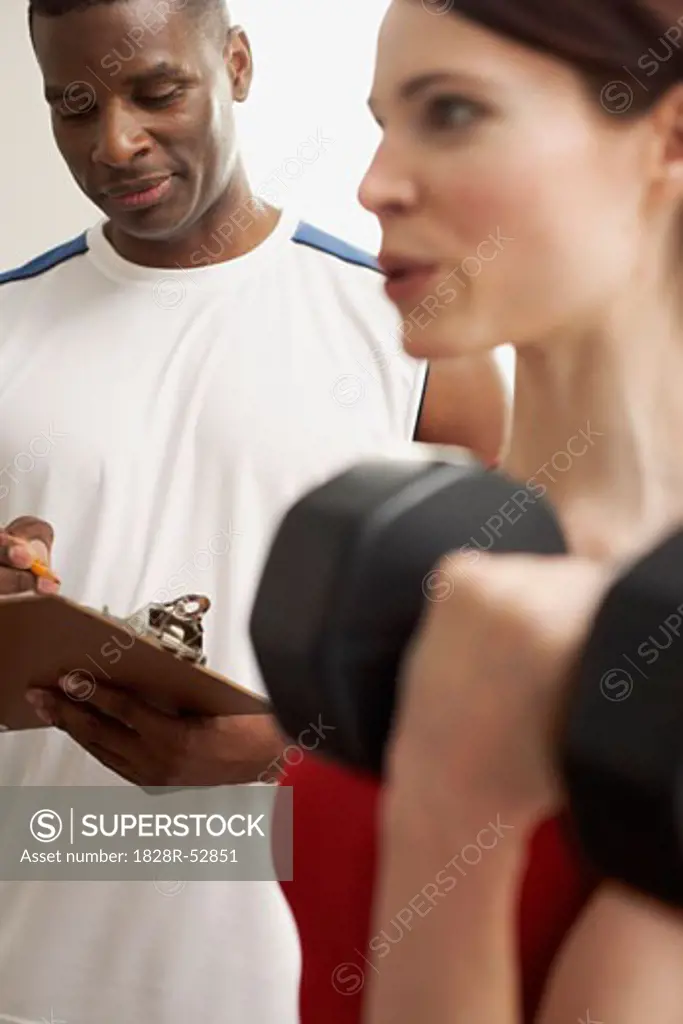 Man and Woman Lifting Weights   