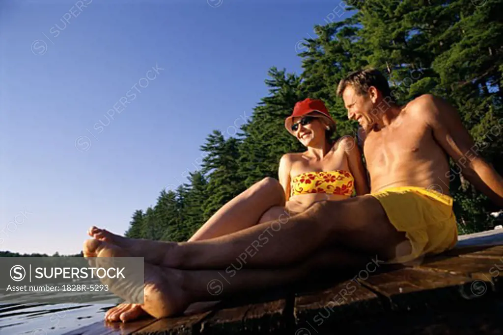 Couple in Swimwear, Relaxing on Dock, Belgrade Lakes, Maine, USA   