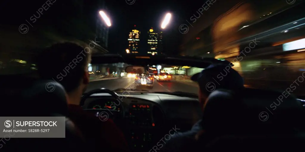 Two Men Driving in Car at Night, Toronto, Ontario, Canada   