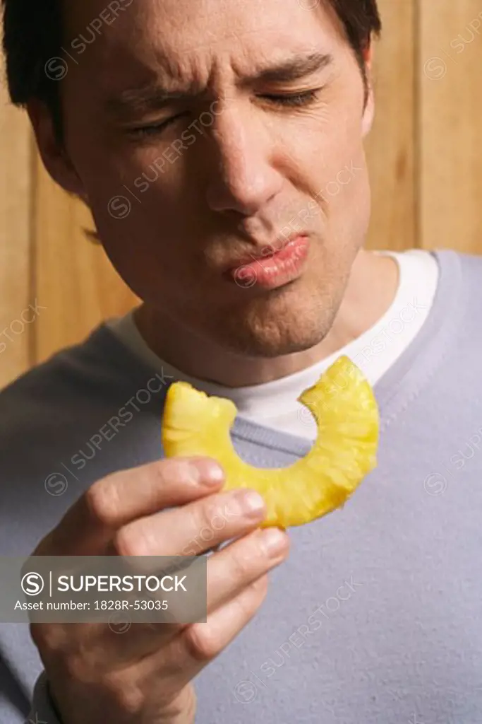 Man Eating Pineapple Slice   