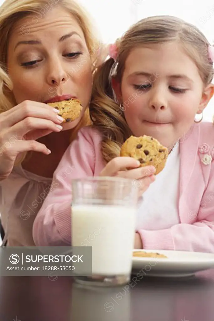 Mother and Daughter Eating Milk and Cookies   