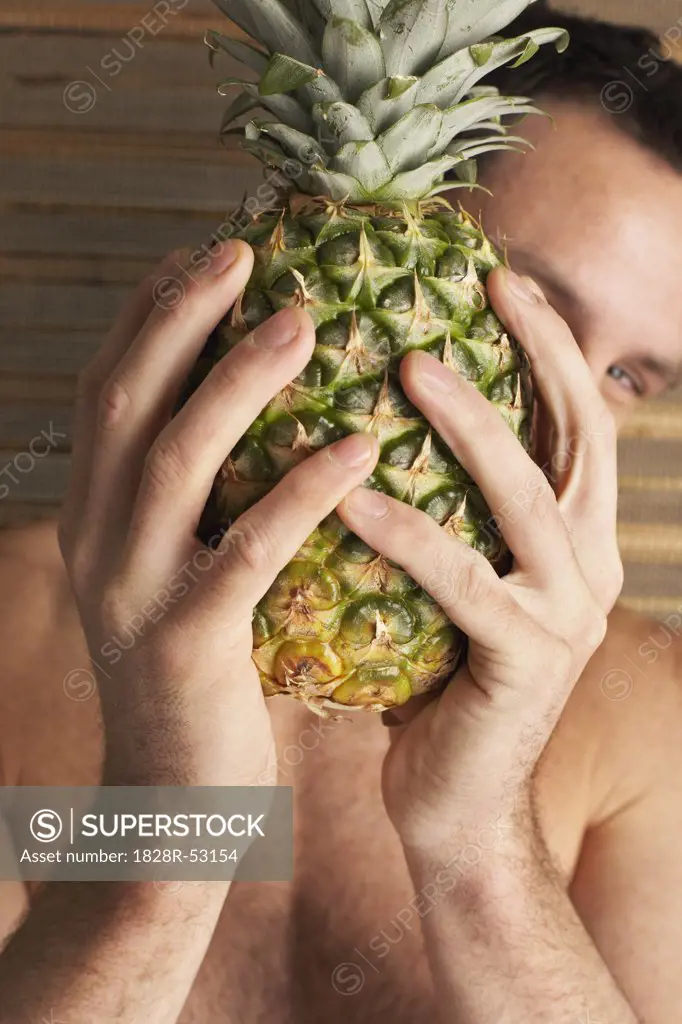 Man Holding Pineapple   