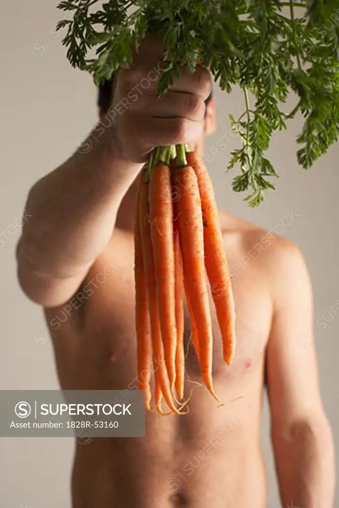 Man Holding Carrots   