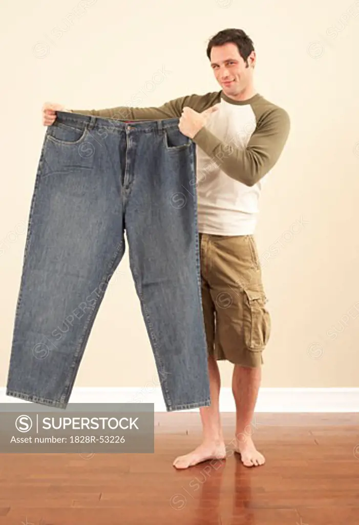 Man Holding Oversized Pants   
