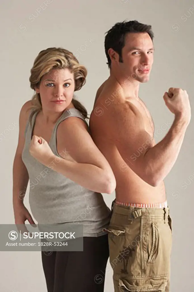 Portrait of Couple Flexing Their Arms   