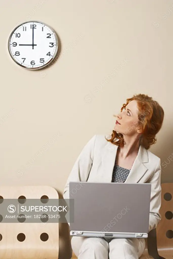 Businesswoman Looking at Clock   