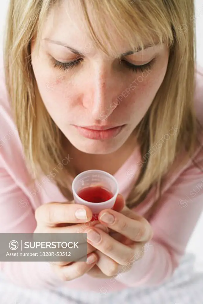 Woman Holding Cough Syrup   