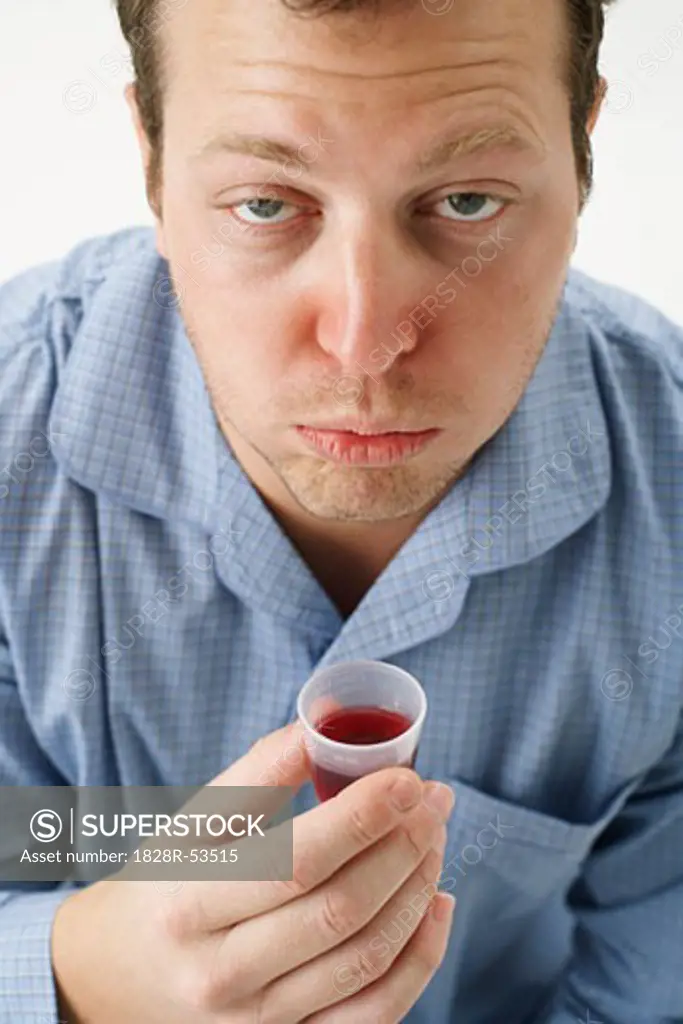 Man Holding Cough Syrup   