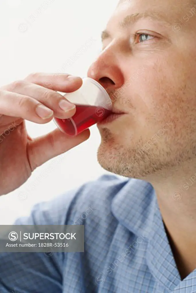 Man Drinking Cough Syrup   