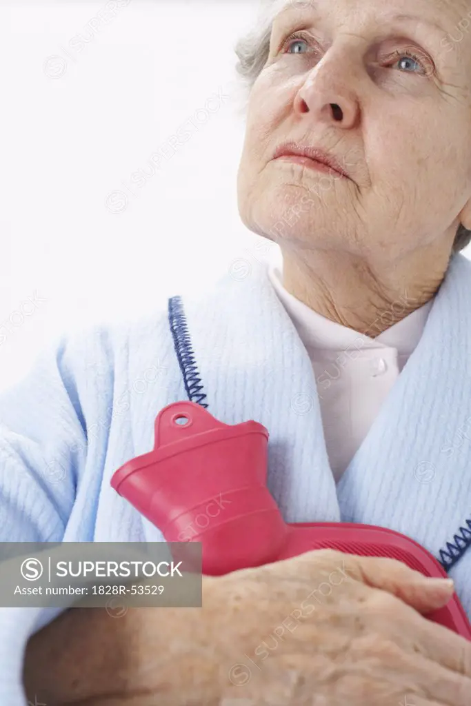 Portrait of Elderly Woman Holding Hot Water Bottle   