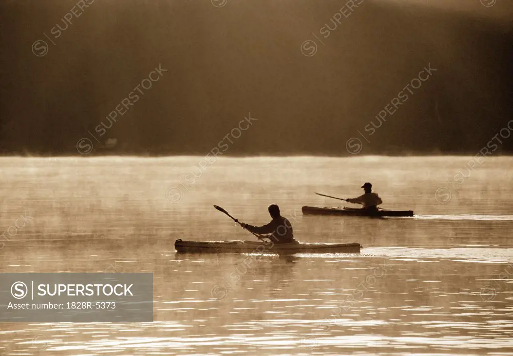 Silhouettes of People Kayaking   