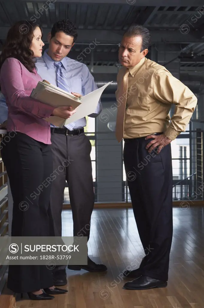 Business People Looking at Document   
