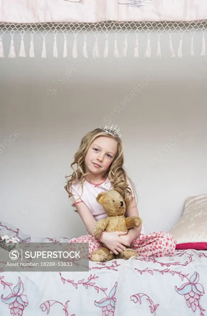 Girl Sitting on Bed, Holding Teddy Bear and Wearing Tiara   