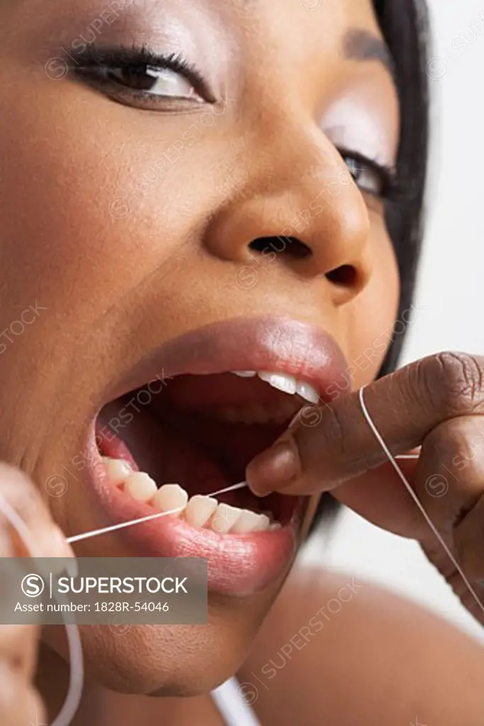Woman Flossing Teeth   