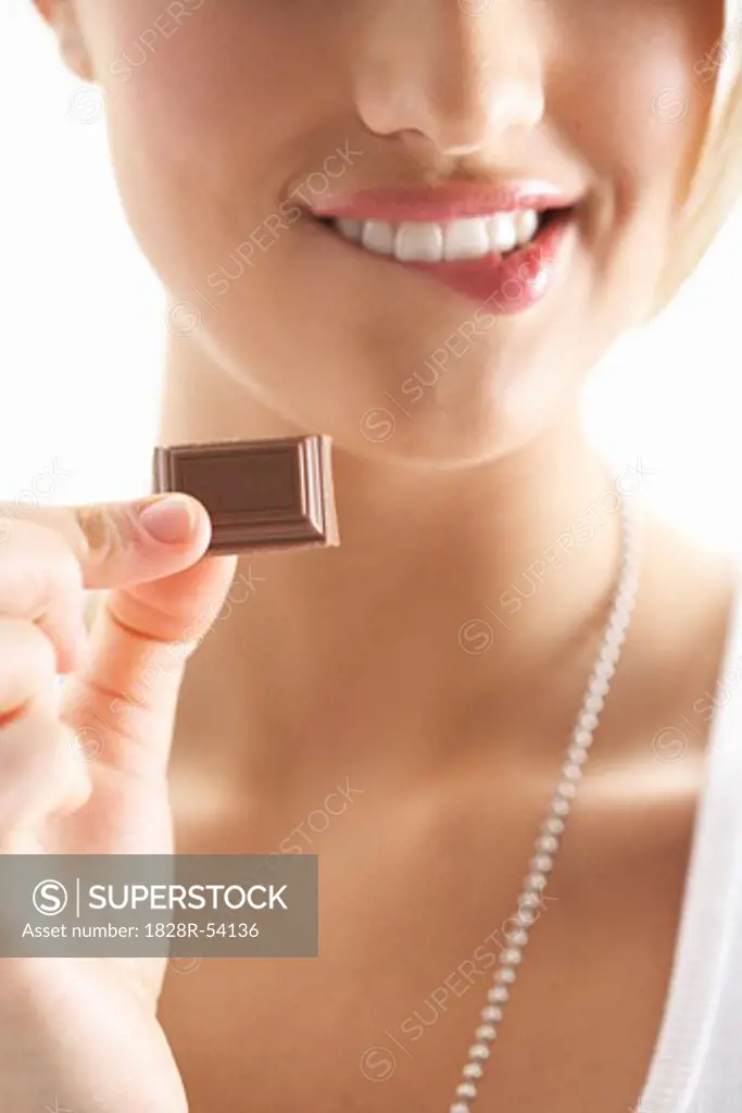 Girl Holding Piece of Chocolate   