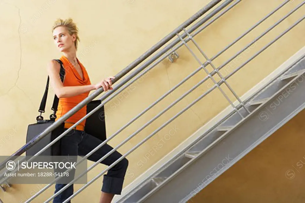 Businesswoman Walking Up Stairs   