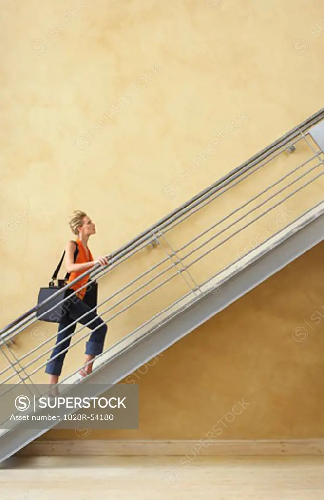 Businesswoman Walking Up Stairs   