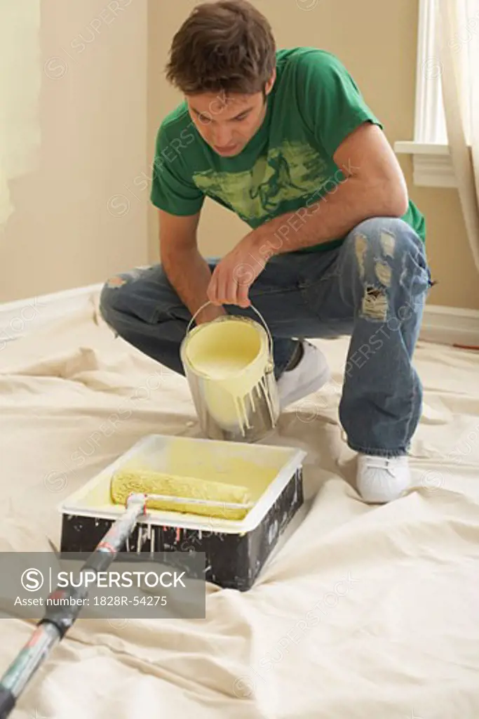 Man Pouring Paint into Tray   