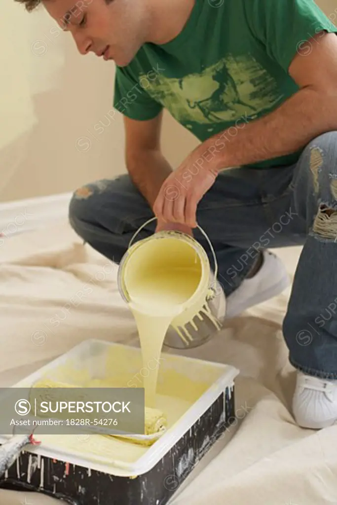 Man Pouring Paint into Tray   